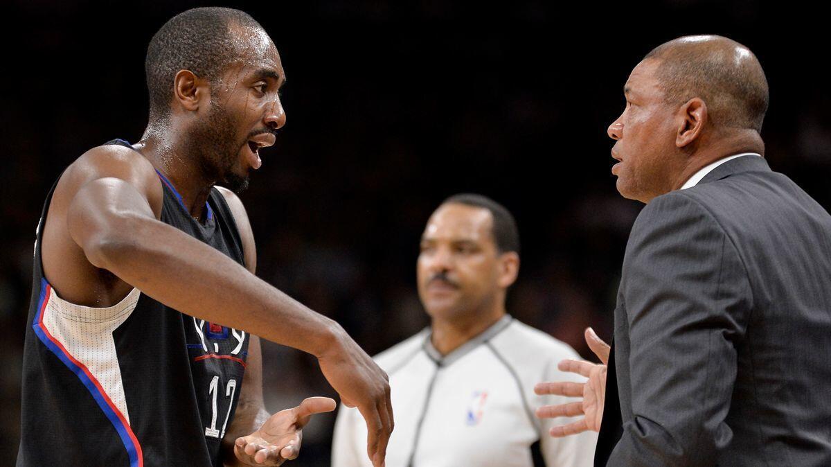 Clippers forward Luc Mbah a Moute, left, talks to coach Doc Rivers during the first half against the San Antonio Spurs on Saturday.