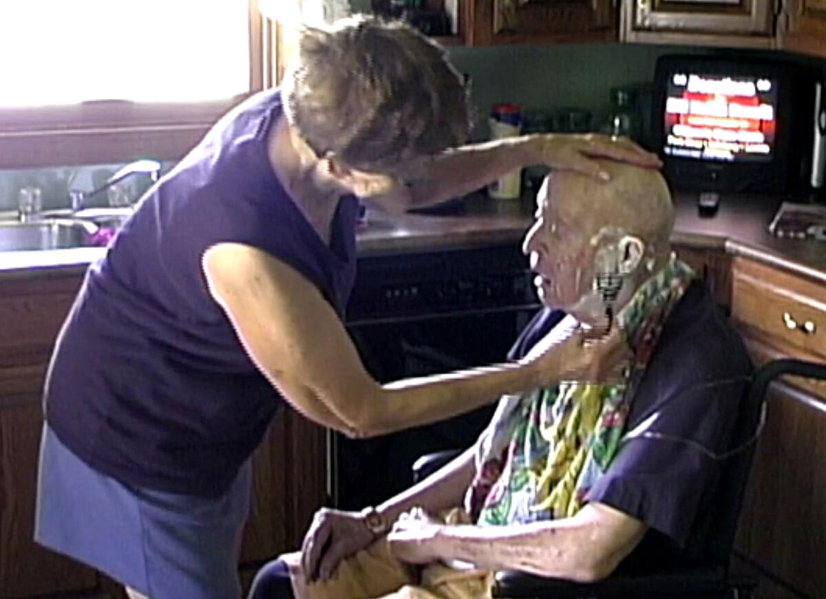 Laura Alkofer assists her husband with grooming as he neared the end of his life.