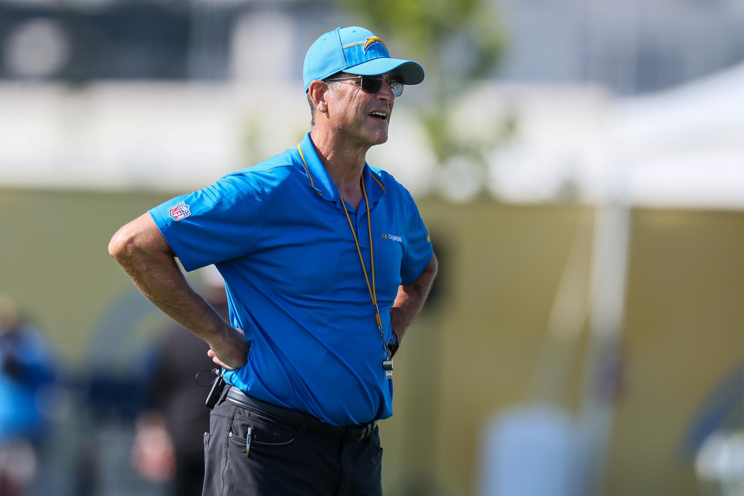 Chargers coach Jim Harbaugh watches from the sideline during training camp at The Bolt. 