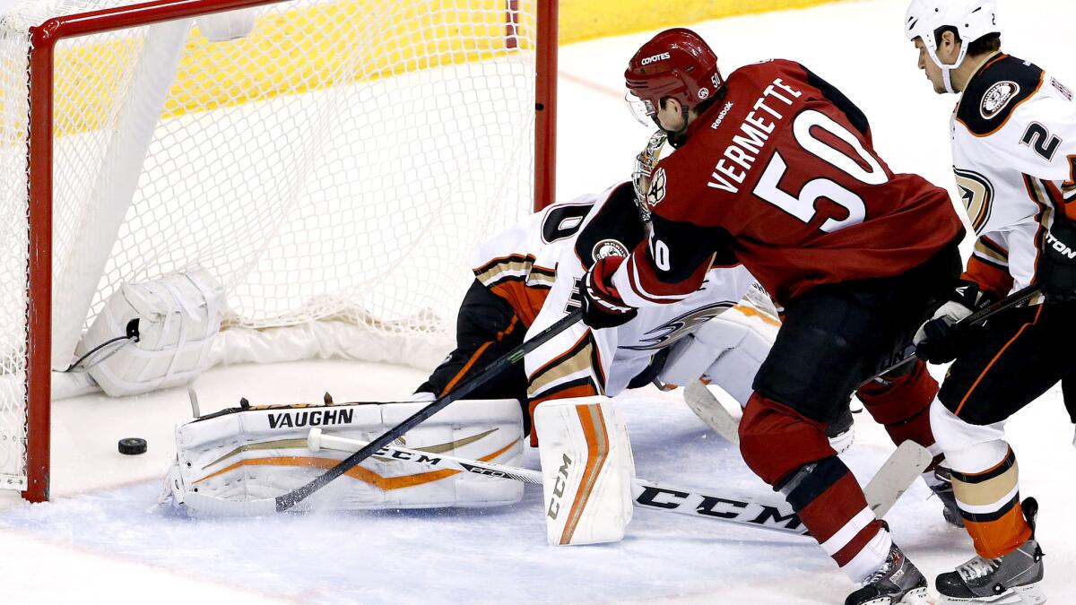 Coyotes center Antoine Vermette (50) scores a goal against Ducks goalie John Gibson and defenseman Kevin Bieksa in the second period Wednesday.