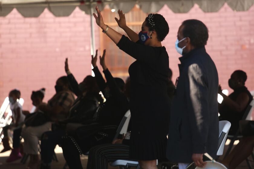Parishioners of Mt. Moriah Church LA worship during a socially distanced outdoor Sunday service