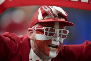 A soccer fan supporting Denmark waits for the start of the World Cup group D soccer match between France and Denmark, at the Stadium 974 in Doha, Qatar, Saturday, Nov. 26, 2022. (AP Photo/Frank Augstein)