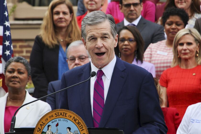North Carolina Democratic Gov. Roy Cooper speaks Monday, March 27, 2023, outside the Executive Mansion in Raleigh, N.C., before signing a Medicaid expansion law that was a decade in the making. (AP Photo/Hannah Schoenbaum)