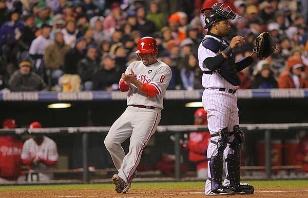 Shane Victorino #8 of the Philadelphia Phillies reacts as he scores in the top of the fourth inning against the Colorado Rockies in Game Three of the NLDS during the 2009 MLB Playoffs at Coors Field in Denver, Colorado.