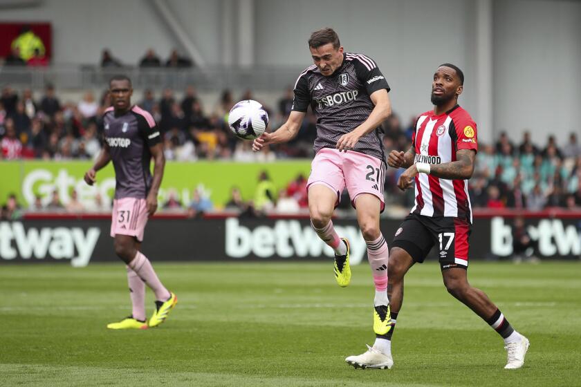 Fulham's Timothy Castagne, left, battles for the ball against Brentford's Ivan Toney during the English Premier League soccer match between Fulham FC and Brentford FC at the Gtech Community Stadium in London, Saturday May 4, 2024. (Rhianna Chadwick/PA via AP)