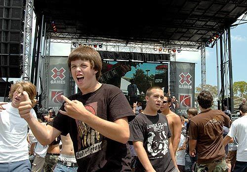 Andrew Lundy, left, 16, of Lakewood, rocks out during the final song of punk group Bad Religion's performance Friday at X Fest at Home Depot Center.