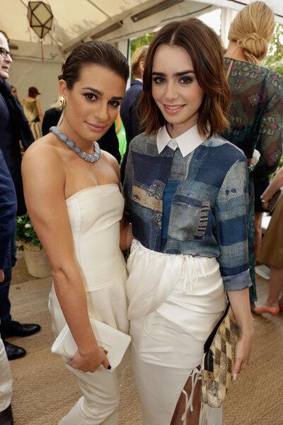 Actresses Lea Michele, left, and Lily Collins attend the 2013 CFDA/Vogue Fashion Fund event. Collins is wearing Altuzarra's "Chika" boro-printed blouse and "Pagoda" white silk and cupro draped skirt from the spring/summer 2014 collection.
