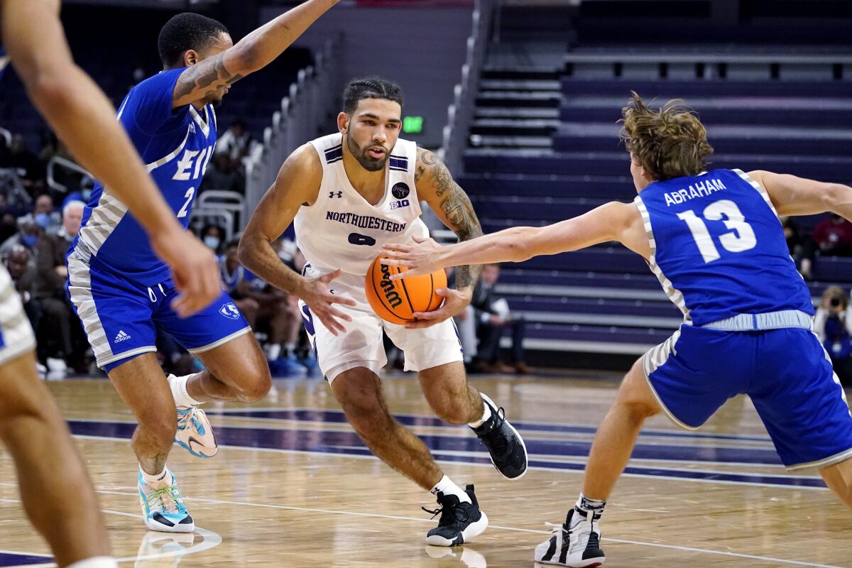 Northwestern guard Boo Buie, center, drives against Eastern Illinois guard Myles Baker, left, and guard Henry Abraham during the second half of an NCAA college basketball game in Evanston, Ill., Tuesday, Nov. 9, 2021. (AP Photo/Nam Y. Huh)