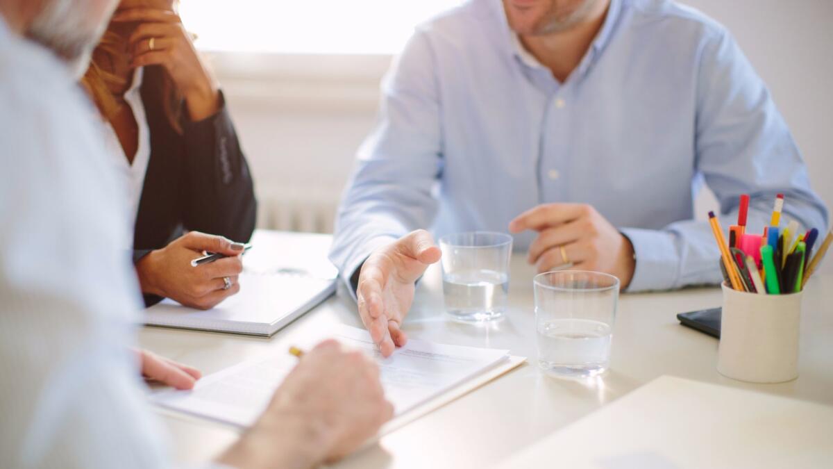 Colleagues at a boardroom table.