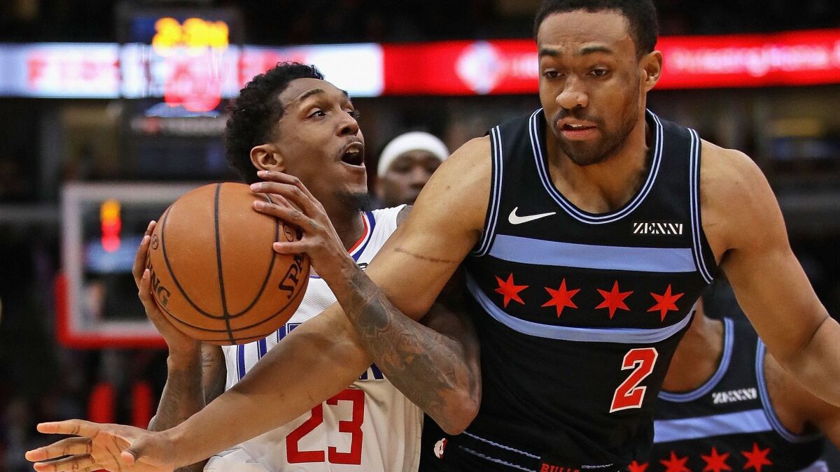 Clippers guard Lou Williams drives against Bulls forward Jabari Parker during the first half Friday.