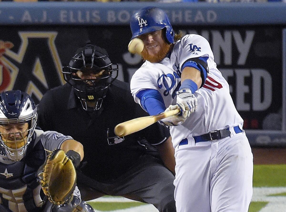 Justin Turner hits a two-run home run in the eighth inning to give the Dodgers a 2-1 victory over the San Diego Padres on Aug. 21 at Dodger Stadium.