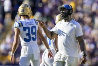 UCLA coach DeShaun Foster talks to kicker Blake Glessner during the Bruins' loss to LSU on Sept. 21 in Baton Rouge, La. 