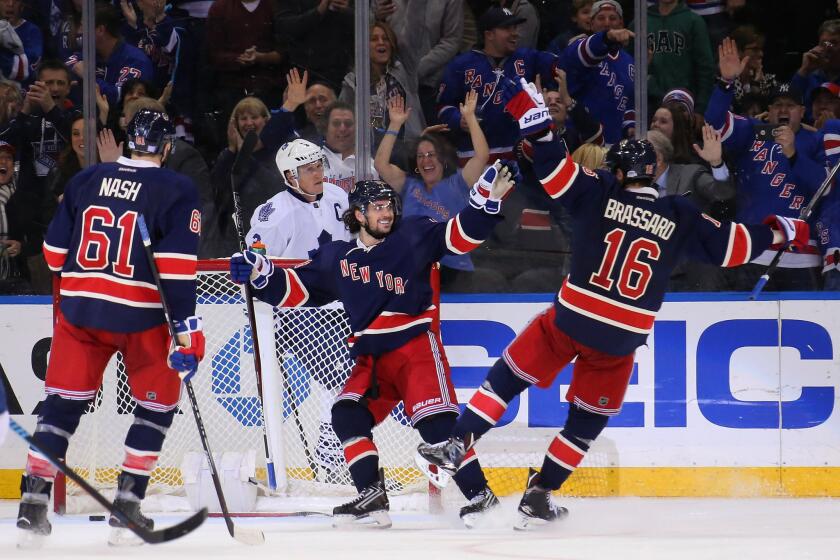 Rangers forward Mats Zuccarello, center celebrates scoring at hat trick against the Maple Leafs with teammates Rick Nash (61) and Derick Brassard (16).