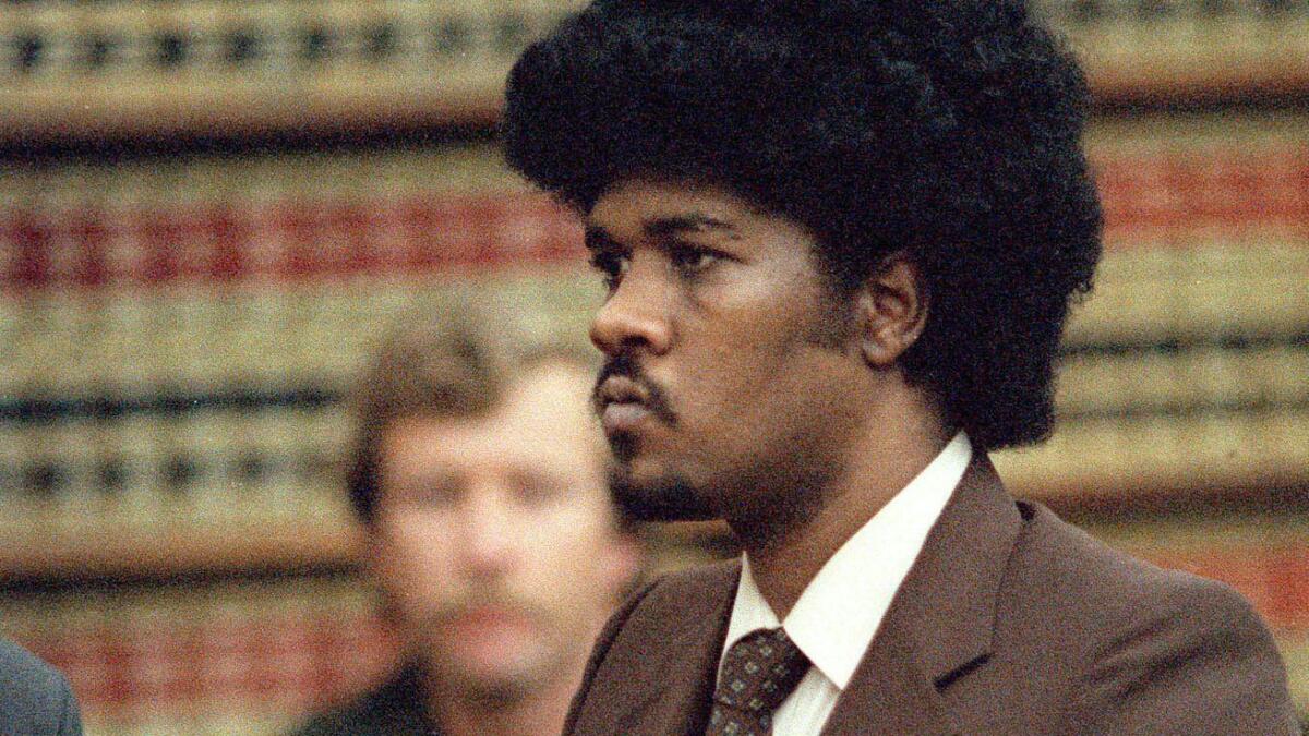 Convicted murderer Kevin Cooper stands before a San Diego judge in this May 1985 file photo when he was sentenced to death for the 1983 slayings of three Chino Hills family members and an unrelated child.