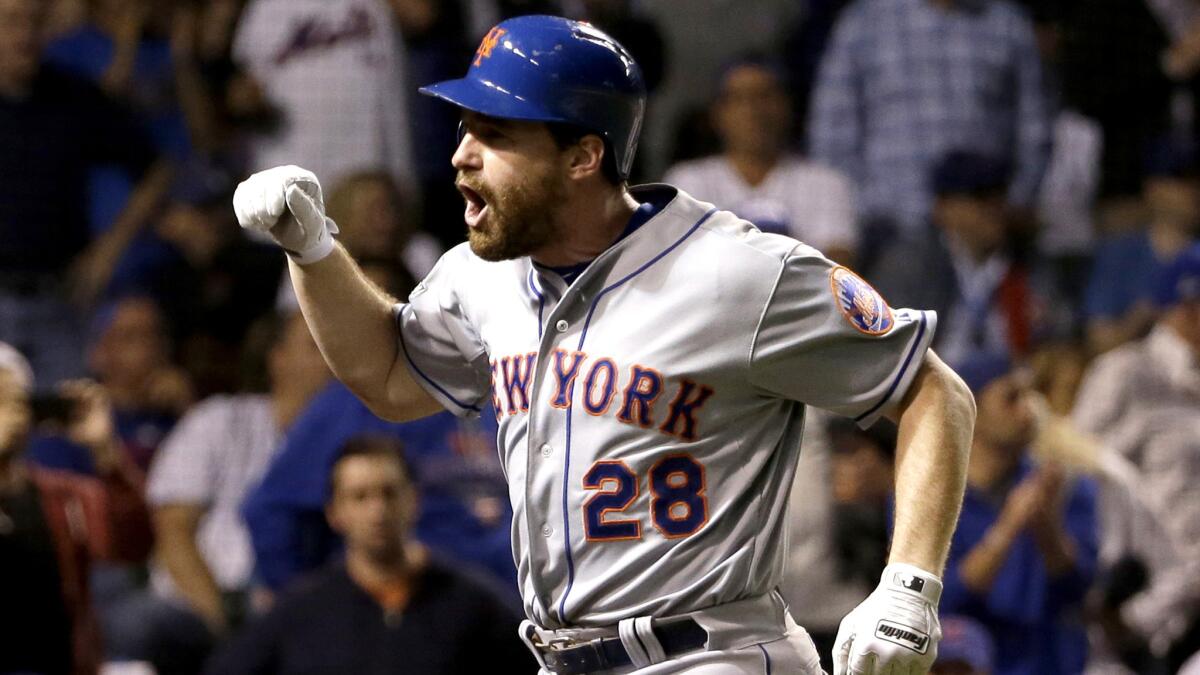Mets second baseman Daniel Murphy, the MVP of the NLCS, celebrates after hitting a two-run home run against the Cubs in the eighth inning of Game 4 on Wednesday night in Chicago.