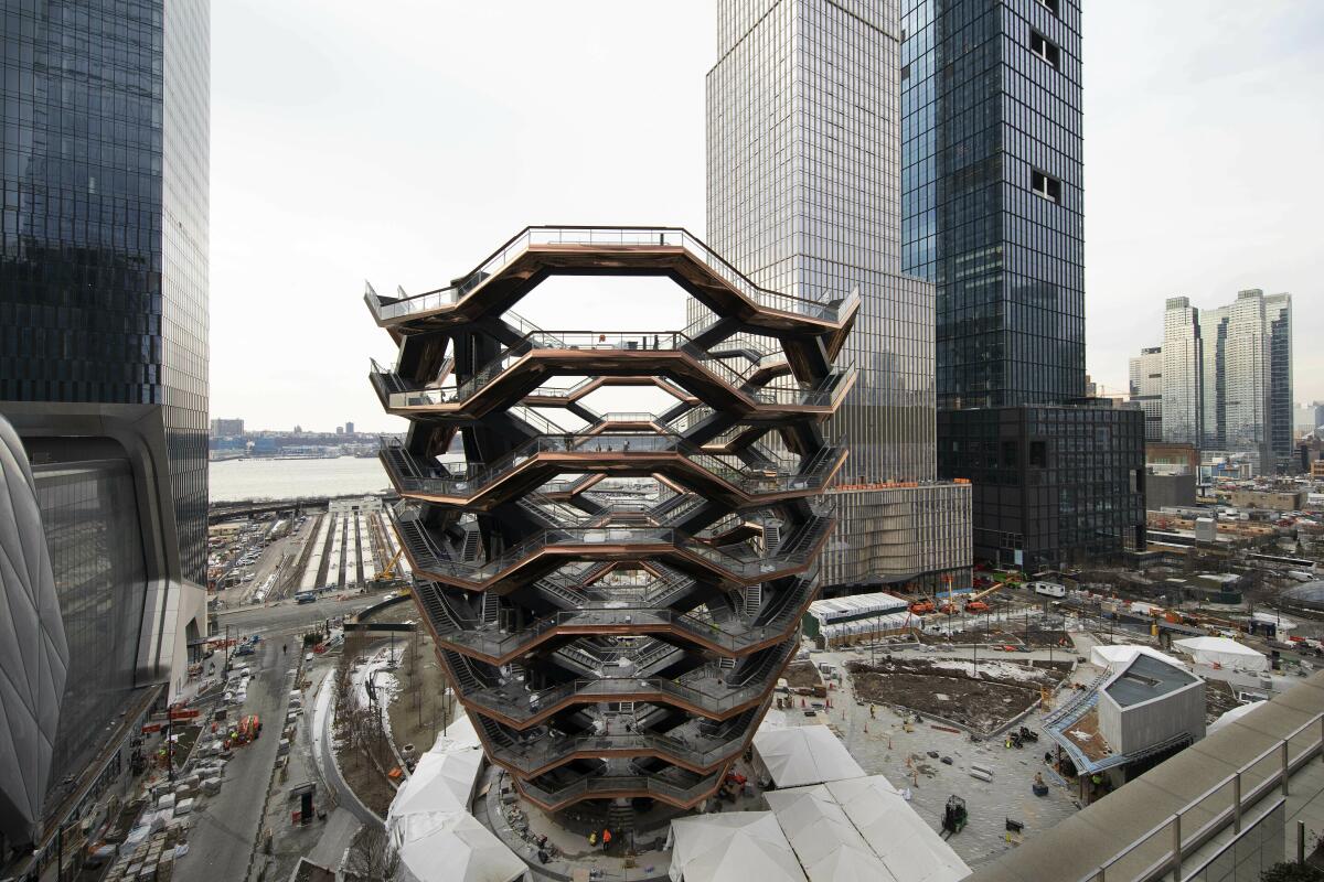 FILE - This March 8, 2019 photo shows the "Vessel," a 150-foot-tall structure of climbable interlocking staircases in the Hudson Yards development in New York. The Vessel, a climbable sculpture that drew hordes of tourists to the Hudson Yards mega-development on Manhattan’s west side before a string of suicides forced its closure in 2021, will reopen to the public later this year with added safety measures. (AP Photo/Mark Lennihan)