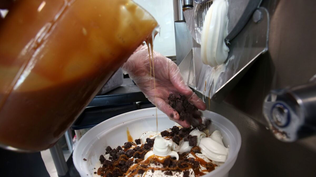 Ken Schulenburg makes a tub of Vanilla Caramel Brownie ice cream at Handel's Homemade, an Encinitas shop that makes more than 50 varieties of gourmet ice cream in-house.