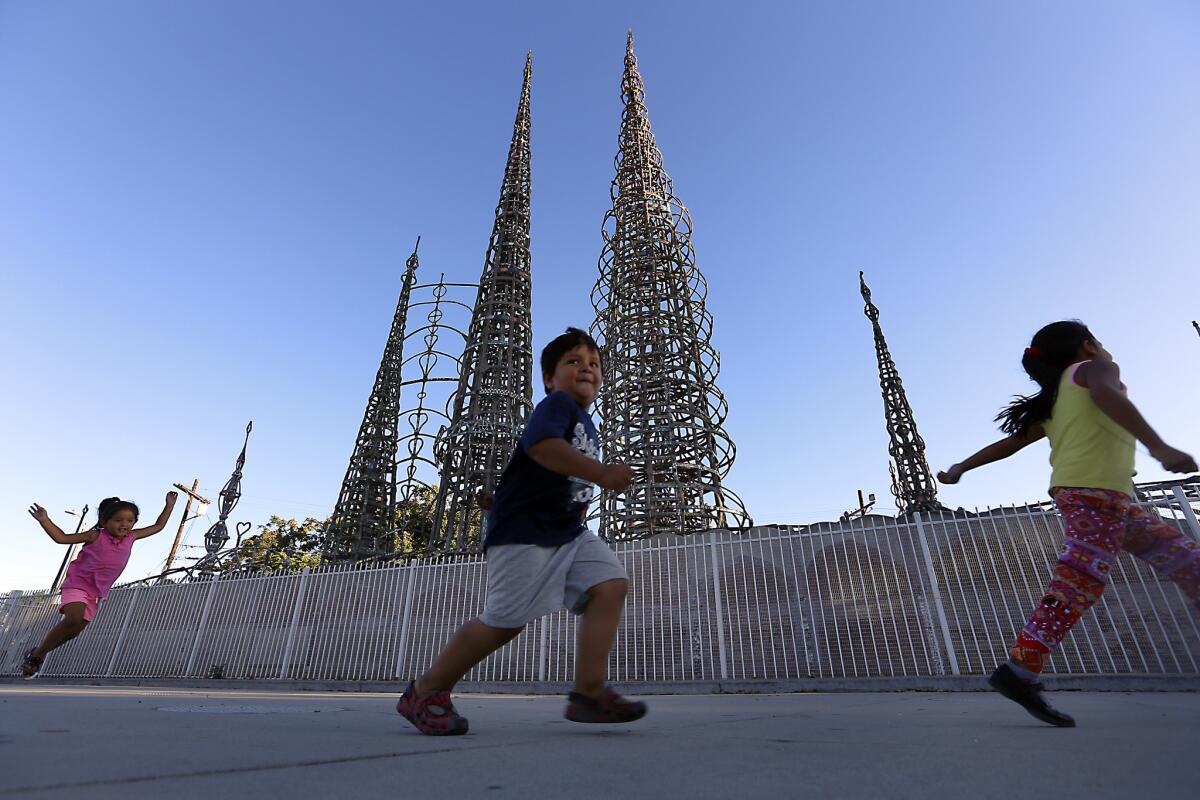 Children play in the park next to the Watts Towers.