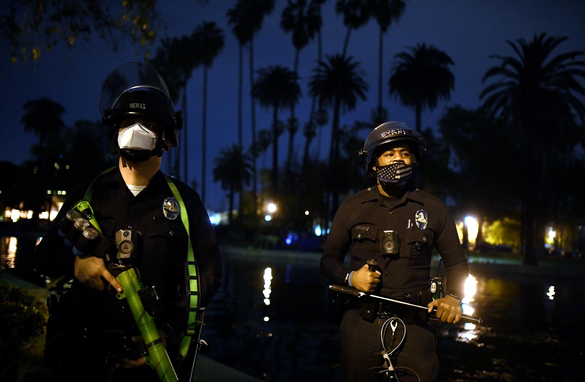 Police officers stand in front of Echo Park Lake camp. 