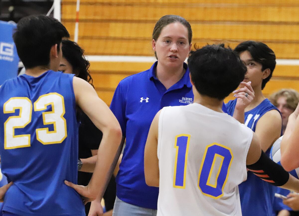 Fountain Valley boys' volleyball coach Rebecca Cheltenham talks with her players during a time out on Thursday.