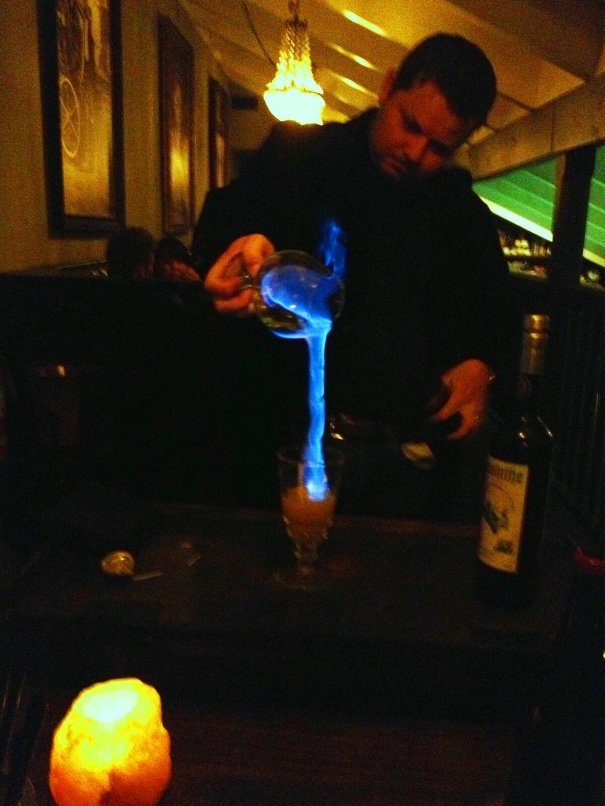 General manager Tobias Peach flames absinthe at Restaurant 1833.