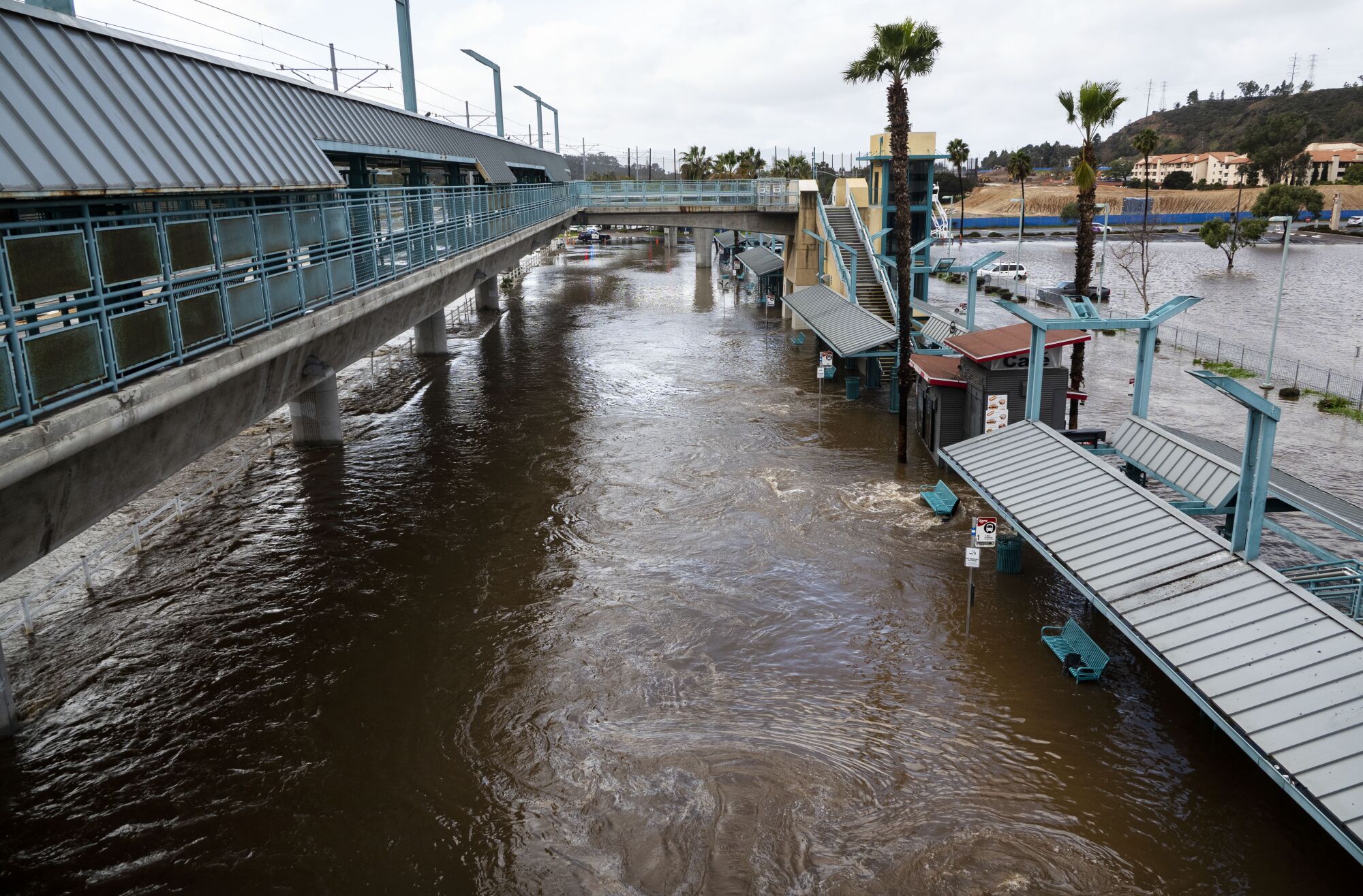 The Fashion Valley Transit Center was flooded near the swollen San Diego River in 