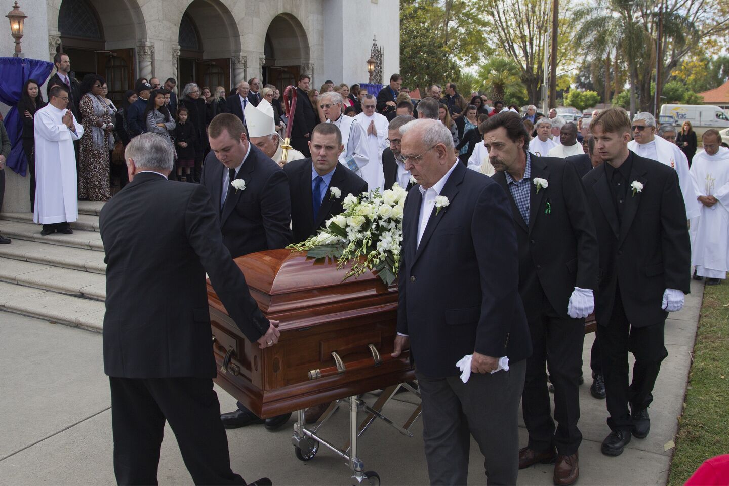 Pallbearers escort the casket of Damian Meins at St. Catherine of Alexandria church in Riverside.
