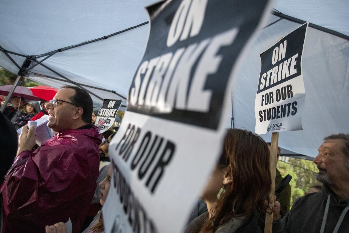 UTLA President Alex Caputo-Pearl, left, kicks off the LAUSD teachers' strike at John Marshall High School in Los Angeles.