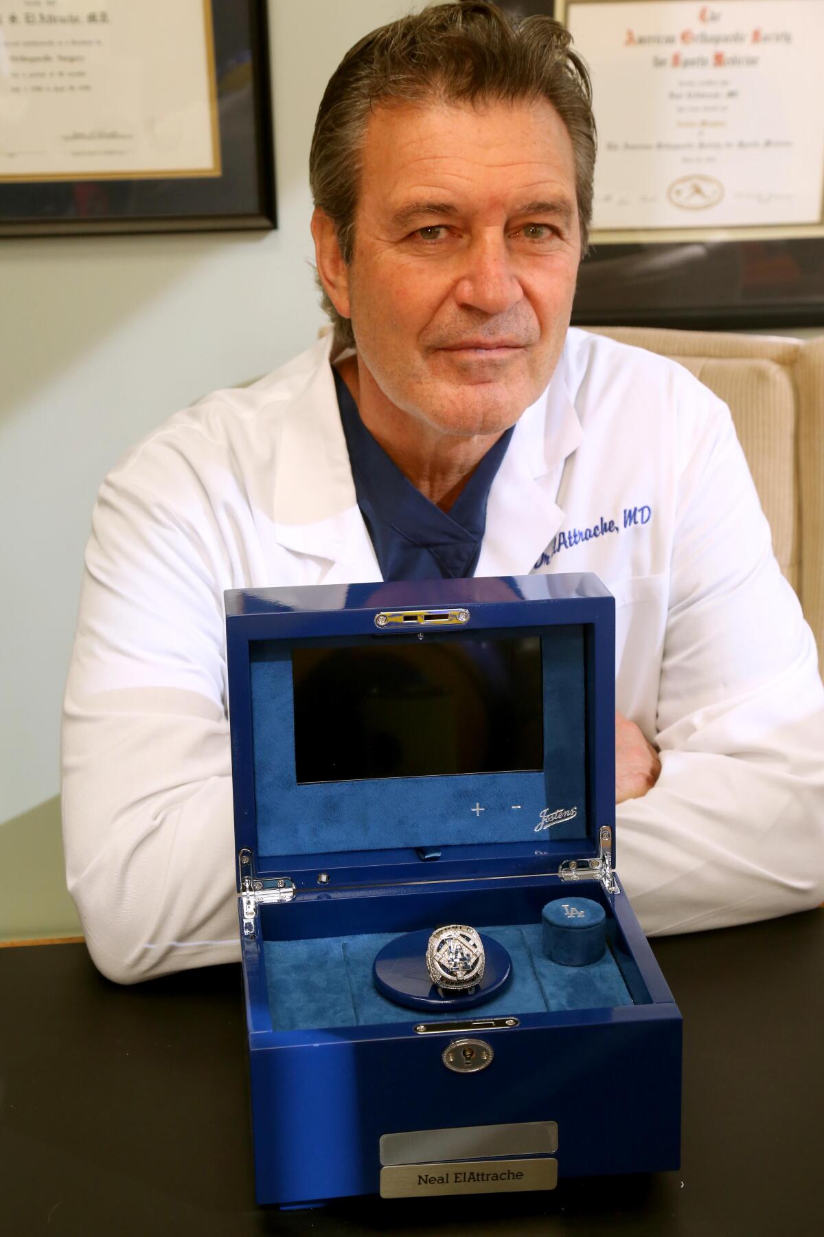 Dr. Neal ElAttrache sits with the 2020 World Series ring presented to him by the Dodgers in his office on Dec. 13, 2023.