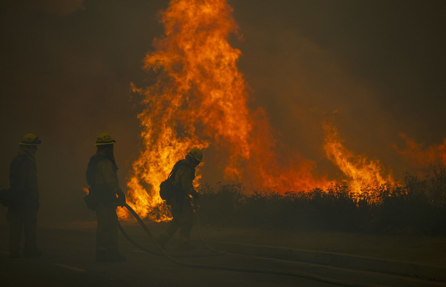 Firefighters struggle to keep the Holy fire from jumping Lincoln Street toward homes in Lake Elsinore.