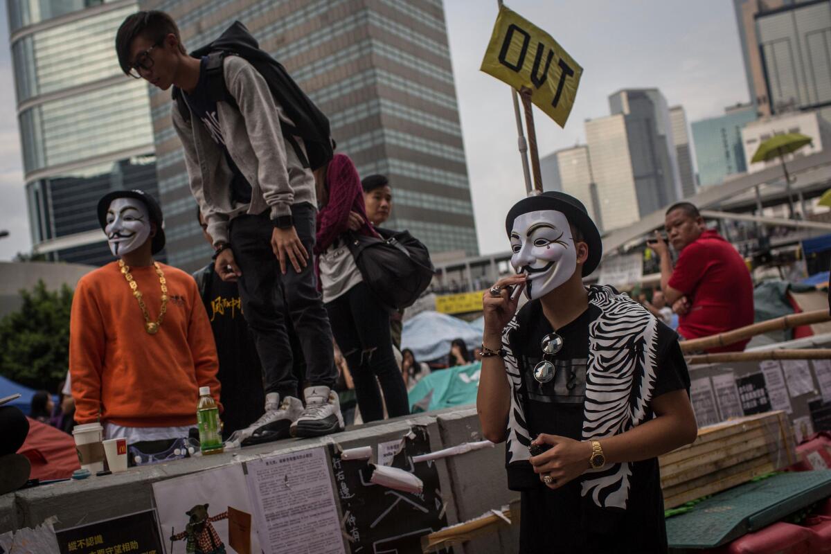 Pro-democracy activists wear masks on a street outside Hong Kong's Government Complex on Oct. 25.