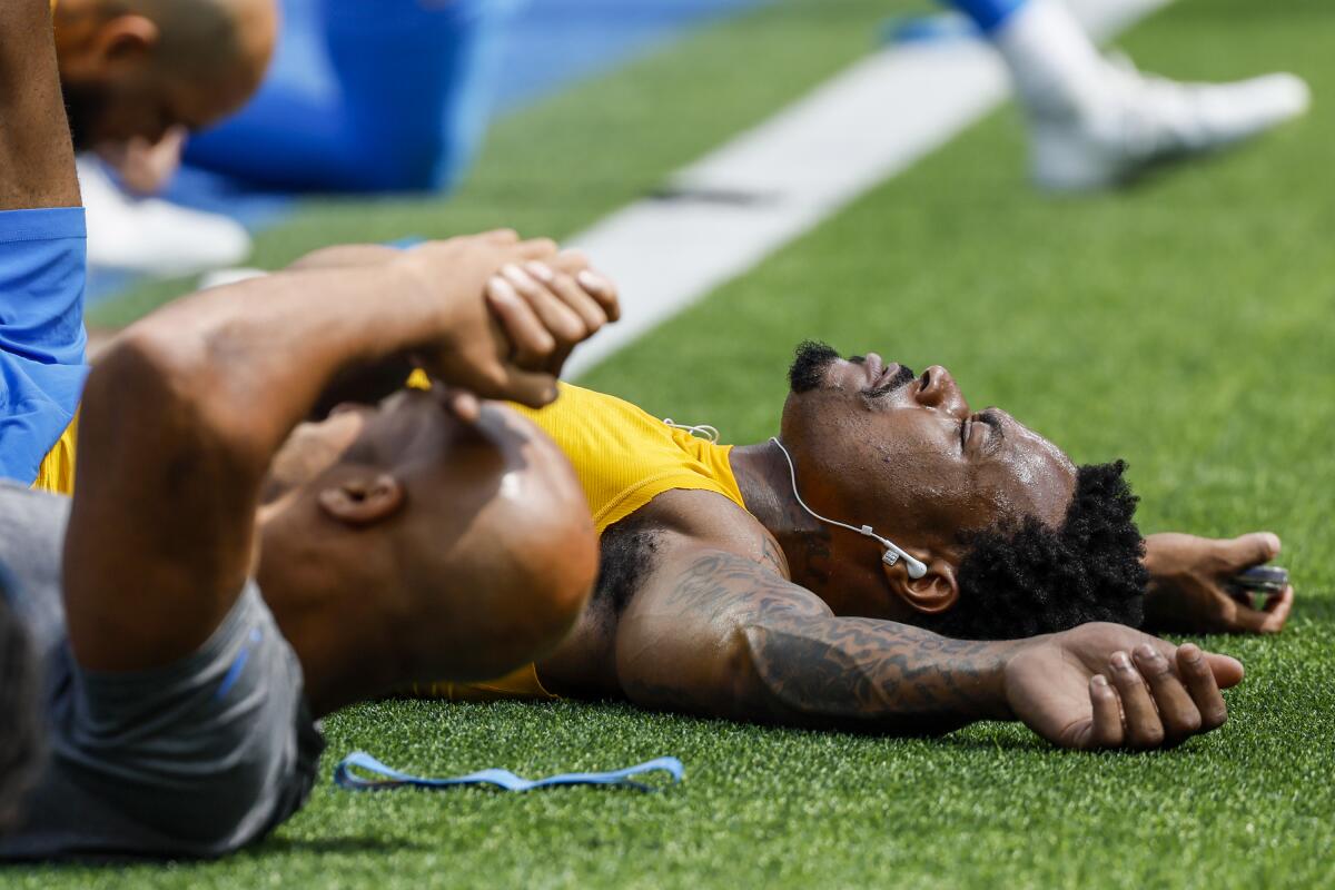 Chargers safety Derwin James stretches with teammates before the team's season opener.