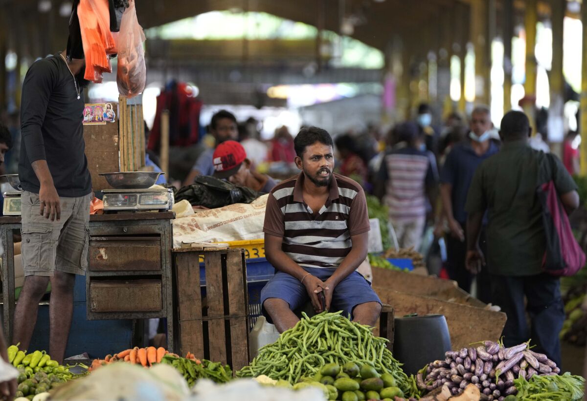 FILE - A vender waits for customers at a vegetable market place in Colombo, Sri Lanka, Friday, June 10, 2022. China’s government on Friday, Feb. 2, 2023, confirmed it is offering Sri Lanka a two-year moratorium on loan repayment as the Indian Ocean island nation struggles to restructure $51 billion in foreign debt that pushed it into a financial crisis. (AP Photo/Eranga Jayawardena)