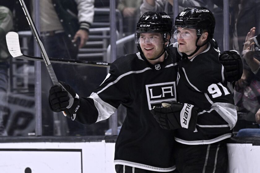 Los Angeles Kings right wing Carl Grundstrom, right, celebrates his goal against the Arizona Coyotes with defenseman Tobias Bjornfot during the second period of an NHL hockey game in Los Angeles, Thursday, Dec. 1, 2022. (AP Photo/Alex Gallardo)