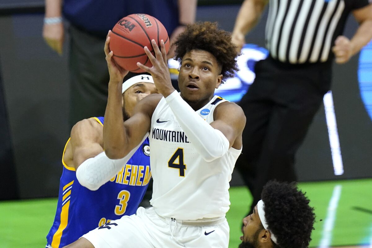 West Virginia's Miles McBride drives to the basket.