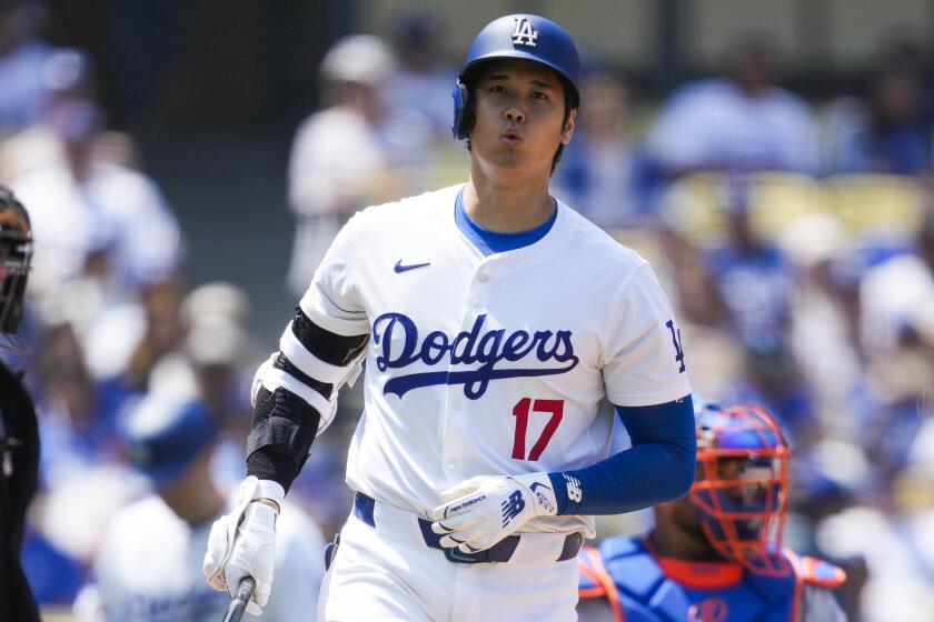 Los Angeles Dodgers designated hitter Shohei Ohtani (17) reacts to a close pitch during.