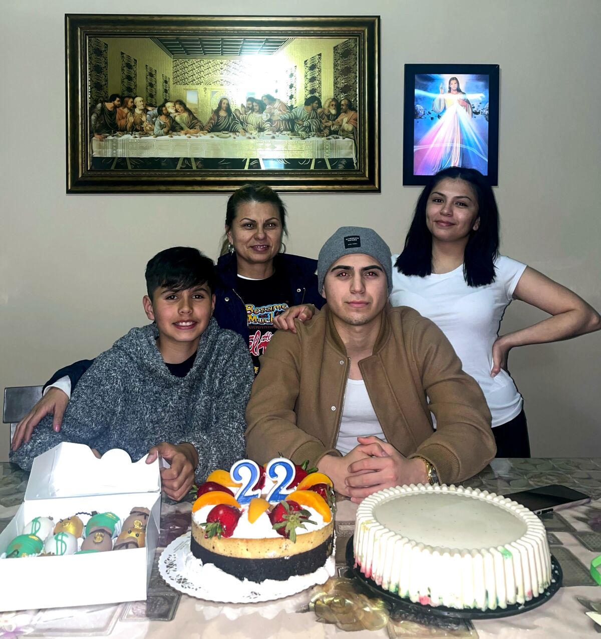 Yolanda Reyna and her three kids at a table with a birthday cake