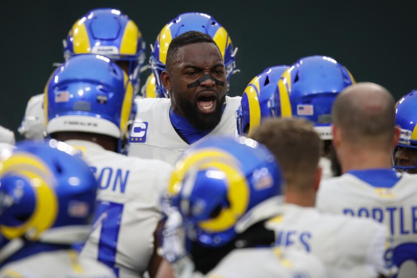 Los Angeles Rams' Michael Brockers, middle, speaks to his teammates before an NFL divisional playoff football game.