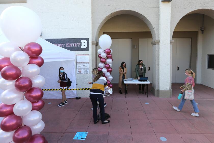 Students arrive for in-person instruction at Laguna Beach High on Wednesday after the school closed one year ago due to the pandemic in 2020.