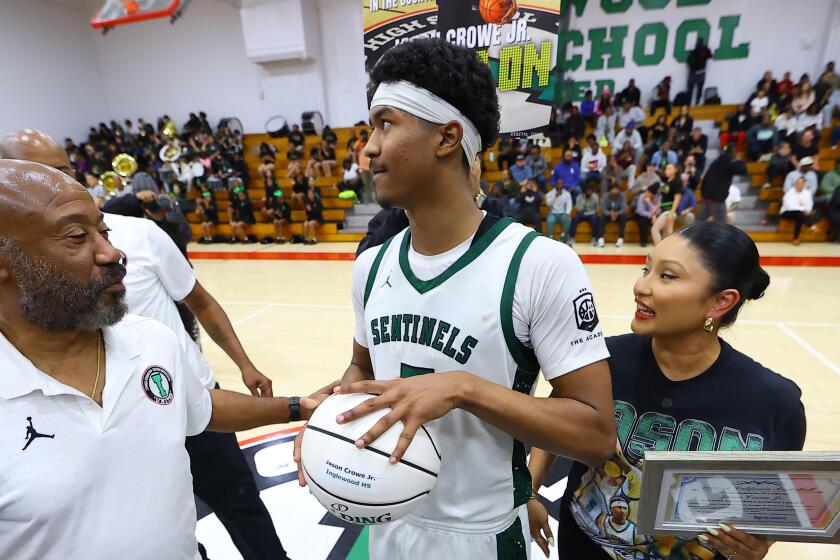 Jason Crowe Jr. of Inglewood gets emotional with his grandfather, Kenneth, and mother Irene.