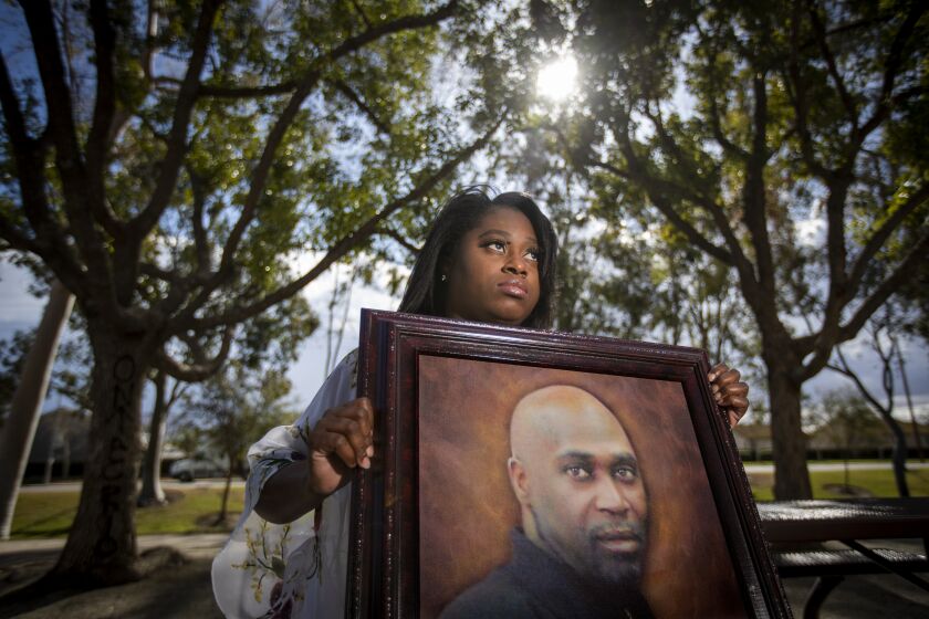 ONTARIO, CA - January 25: Myesha Lopez, 26, who is seeking justice for her father, Michael Thomas, shown in painting, a 62 year-old Black man who was killed by a sheriff's deputy at his Lancaster home last June. Deputies responded to a domestic violence call at his home and Thomas allegedly reached for a deputy's gun during a confrontation. (His family denies both the nature of the 911 call and the claim that Thomas reached for the gun.) Lopez says that the department has provided her with no new information about the case since her father's death, including whether the deputy who shot her is still on the streets. Photo taken at Creekside Park on Monday, Jan. 25, 2021 in Ontario, CA. (Allen J. Schaben / Los Angeles Times)