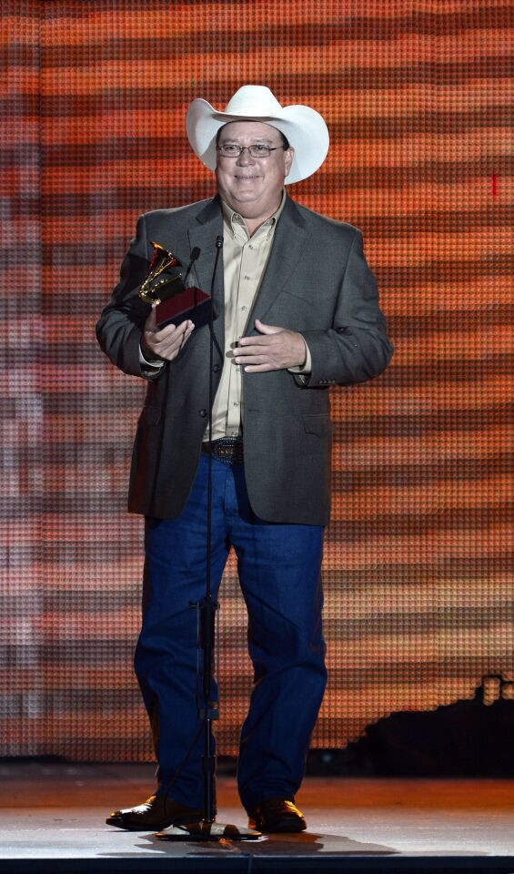 David Lee Garza holds his award for best tejano album for "Just Friends."