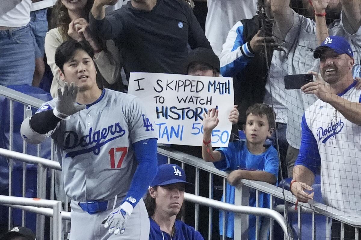 Shohei Ohtani waves to fans after he hit a home run in the seventh inning.