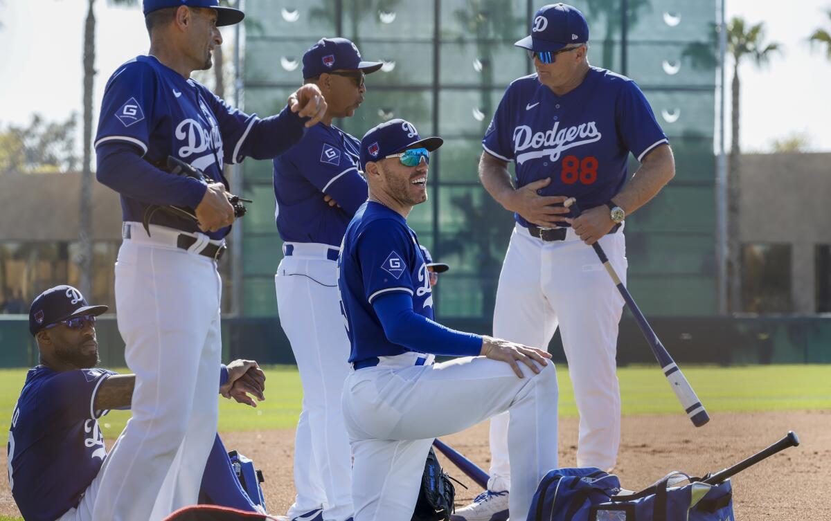 Dodgers first baseman Freddie Freeman, front, looks on from the sideline with teammates