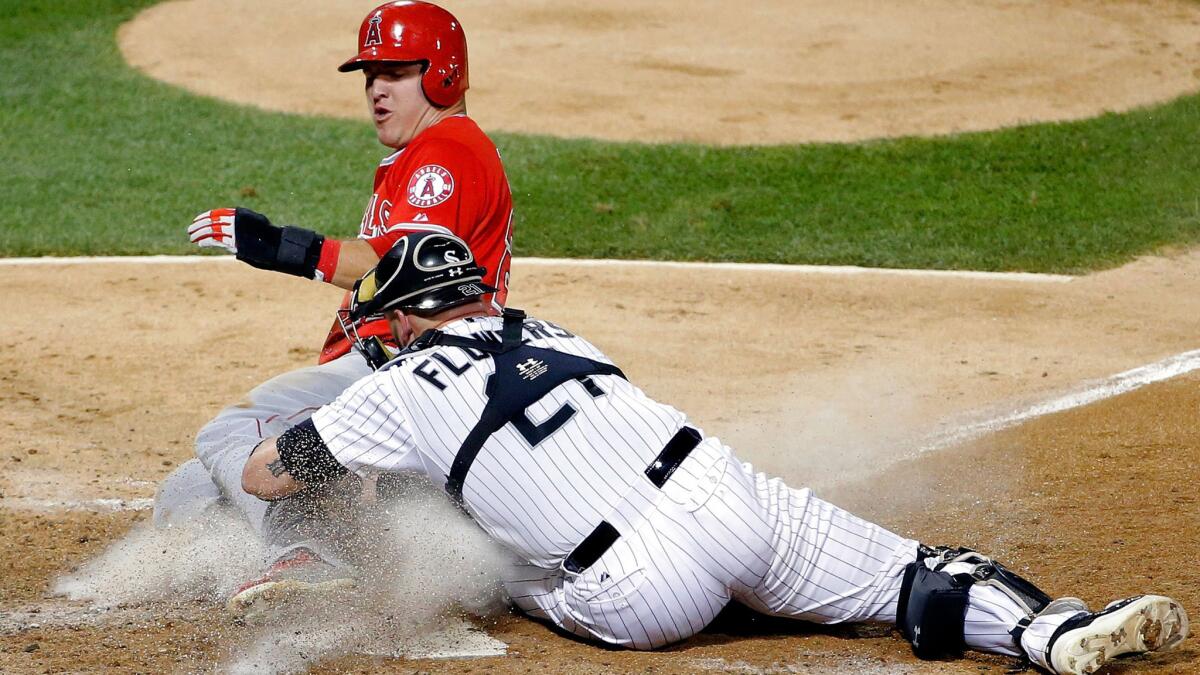 White Sox catcher Tyler Flowers tags out Angels center fielder Mike Trout, who tried to score from third base on an infield grounder, on a play at the plate in the sixth inning Wednesday night.
