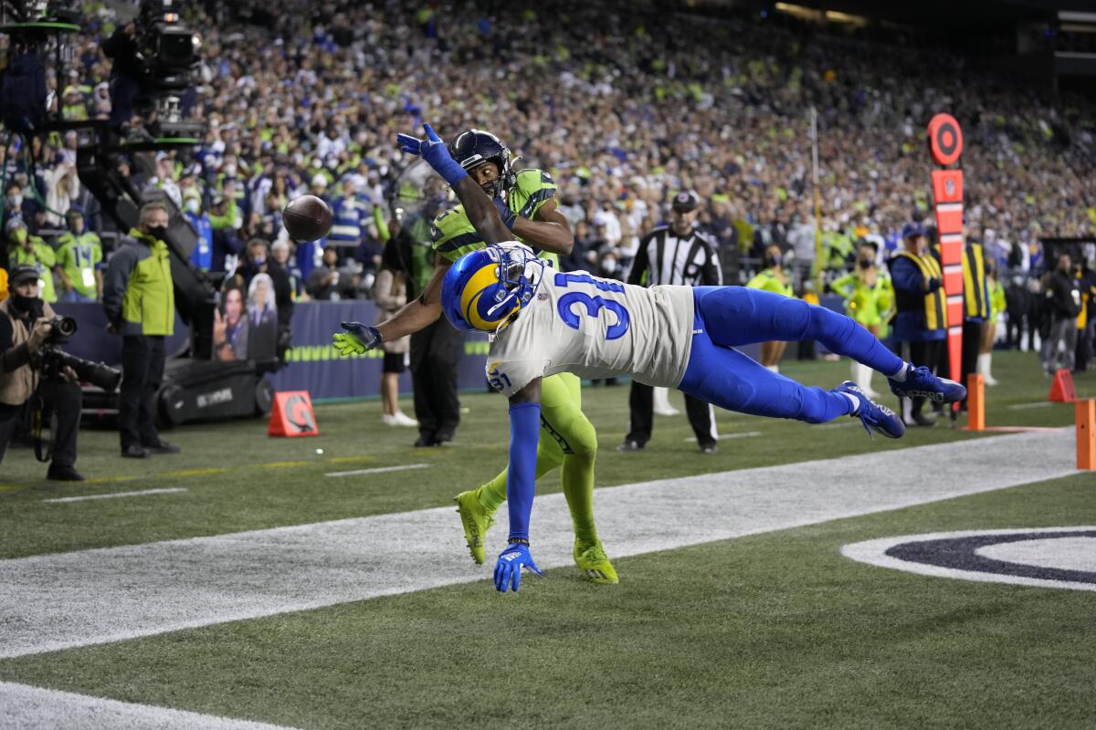 Rams cornerback Robert Rochell knocks the ball away from Seattle Seahawks wide receiver Tyler Lockett.