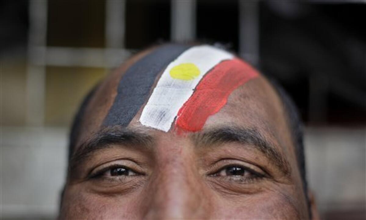 An anti-government protester wears facepaint in the colors of the Egyptian flag during the continuing demonstration in Tahrir square in downtown Cairo, Egypt, Tuesday, Feb. 1, 2011. More than a quarter-million people flooded into the heart of Cairo Tuesday, filling the city's main square in by far the largest demonstration in a week of unceasing demands for President Hosni Mubarak to leave after nearly 30 years in power. (AP Photo/Ben Curtis)