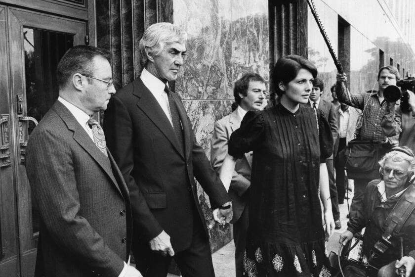 John and Christina DeLorean leaving Federal Court. (Los Angeles Times)
