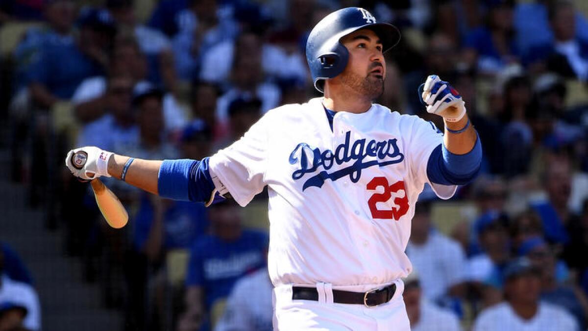 Adrian Gonzalez follows through on a two-run home run against the Nationals in the first inning of Game 4.