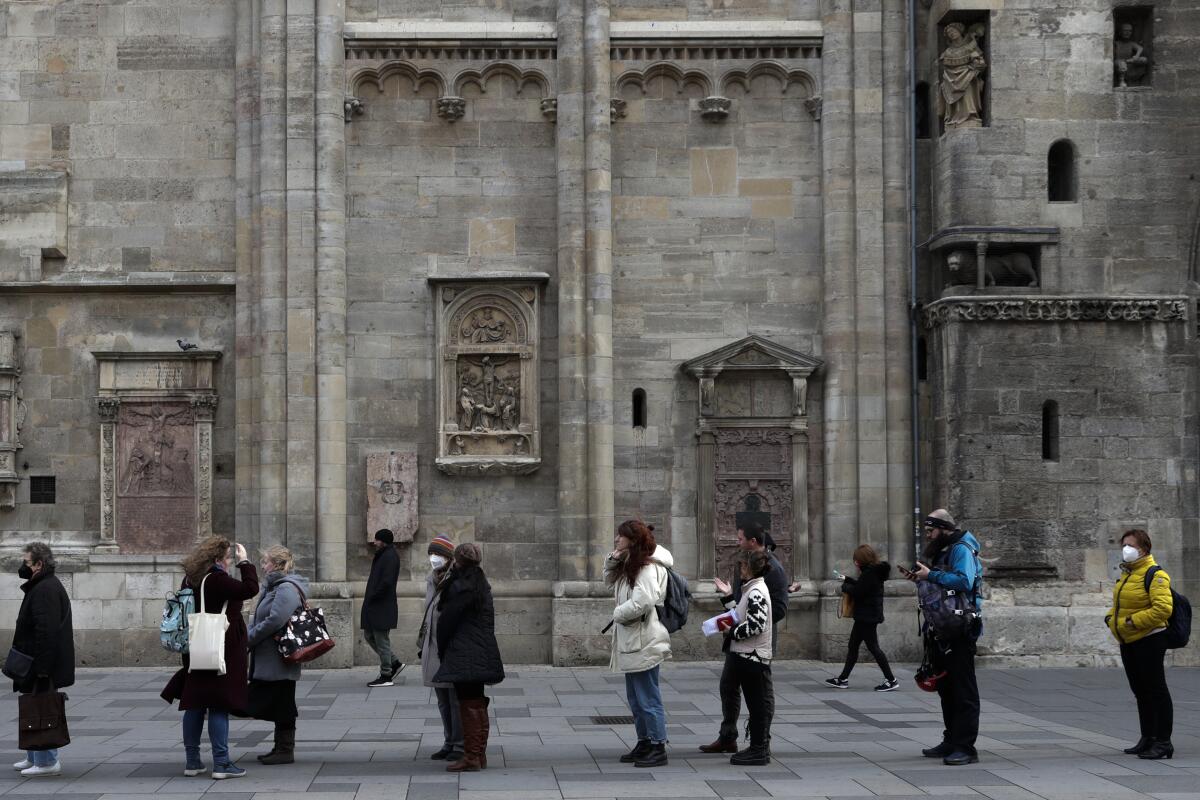 People line up for vaccinations in front of the St. Stephen's Cathedral 